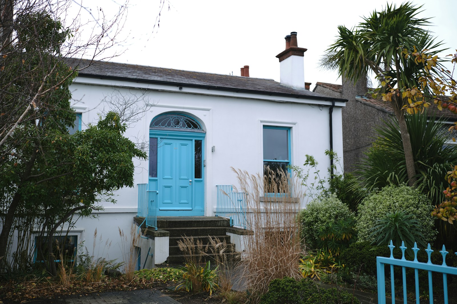 White house with blue front door in Sandymount village, Dublin, Ireland